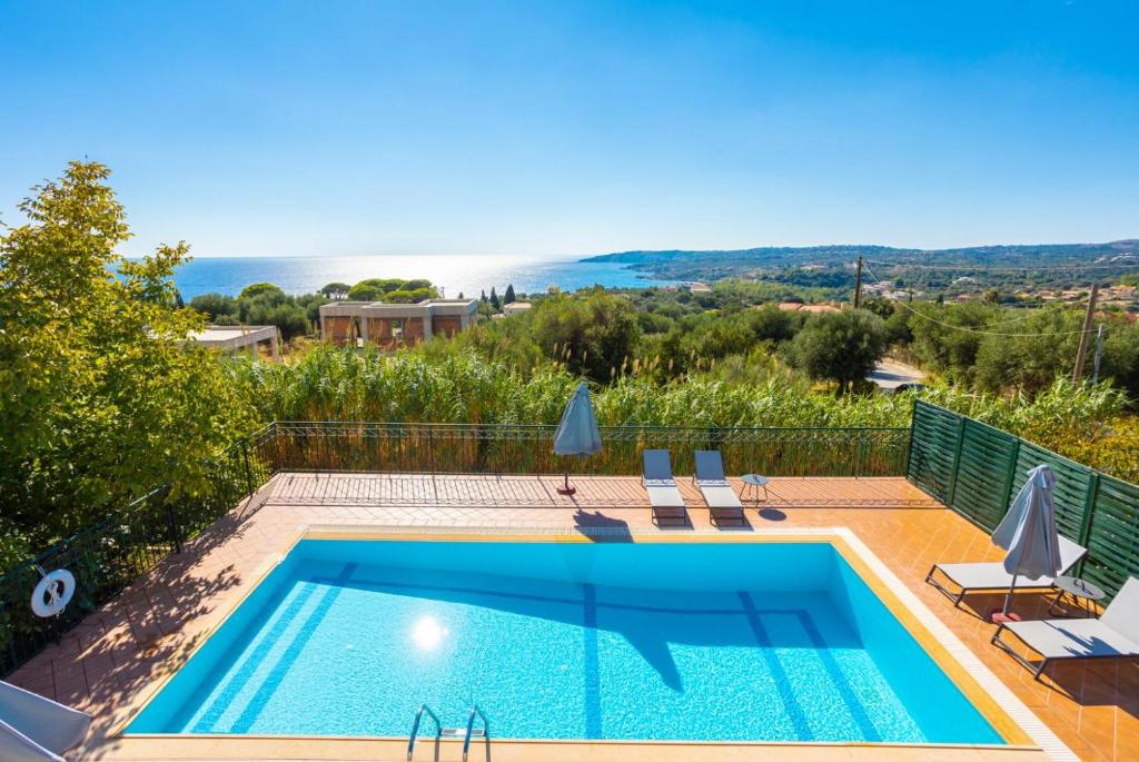 a villa with a pool and a view at Villa Erasmia in Vlachata