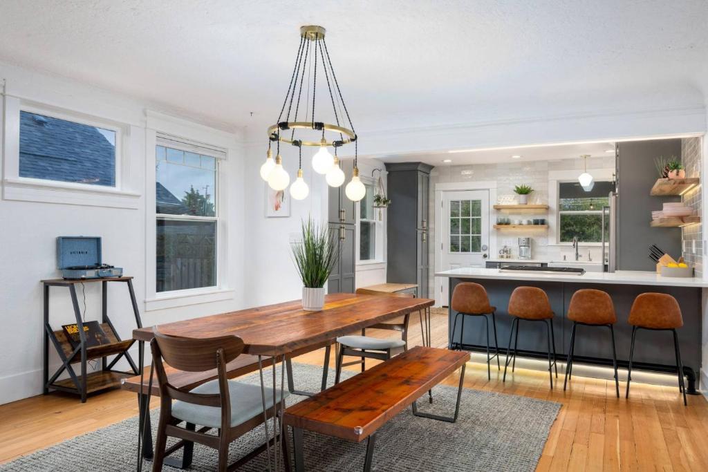 a kitchen and dining room with a wooden table and chairs at Rhone Retreat in Portland