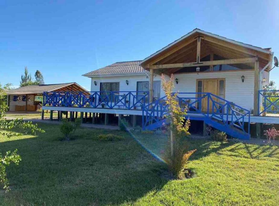 a house with a large deck in the yard at Casona los boldos in Santa Cruz