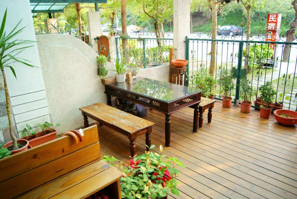 a patio with a table and benches on a deck at Hualien Lidu House in Hualien City