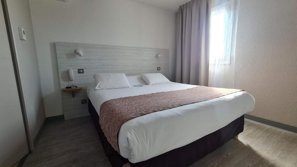 Letto o letti in una camera di Kyriad Montpellier Sud - A709
