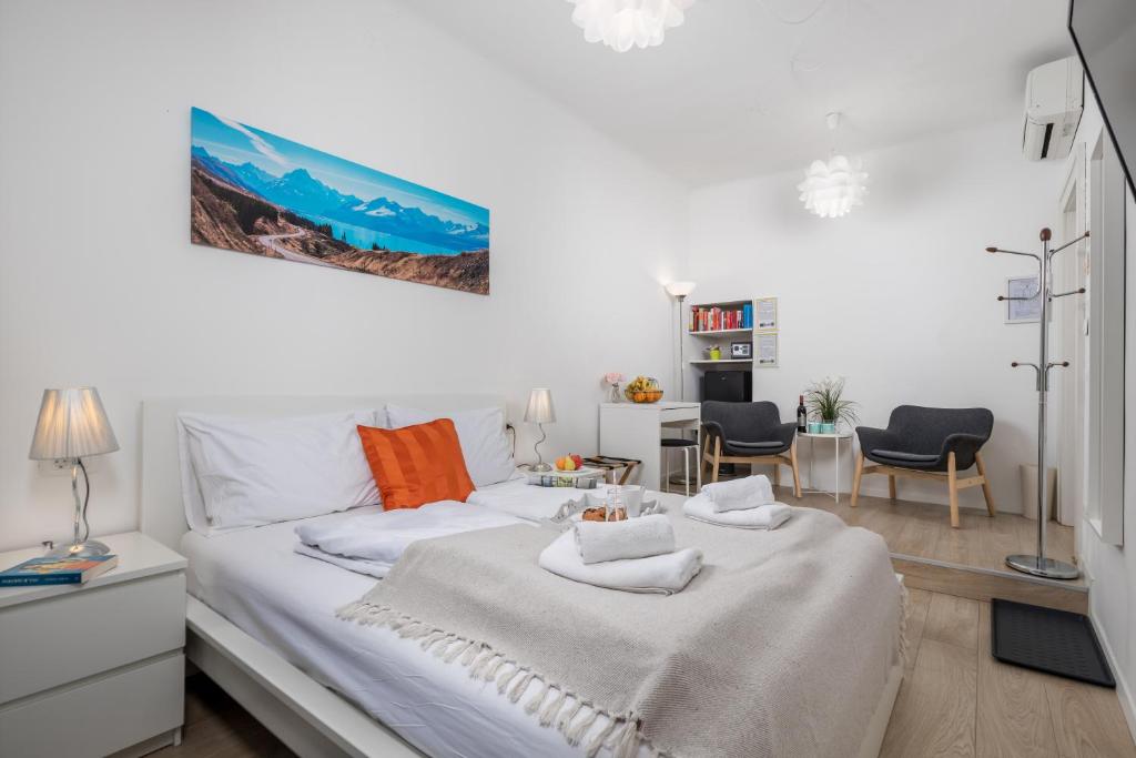 una camera da letto con un letto, un tavolo e delle sedie di Delta Rooms a Fiume (Rijeka)