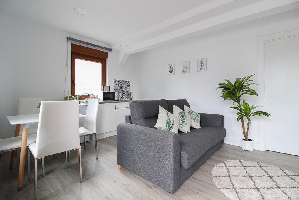 a living room with a couch and a table at La Maruca Beach Santander in Santander