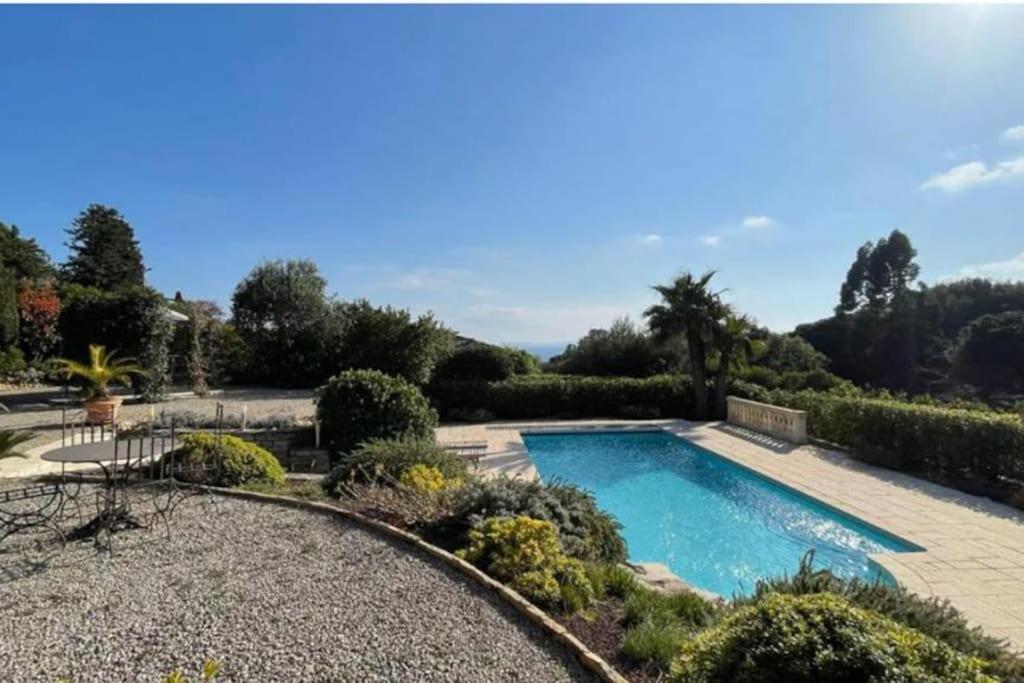 a swimming pool in a garden with a landscaping at Villa avec piscine, plage à pieds in La Croix-Valmer