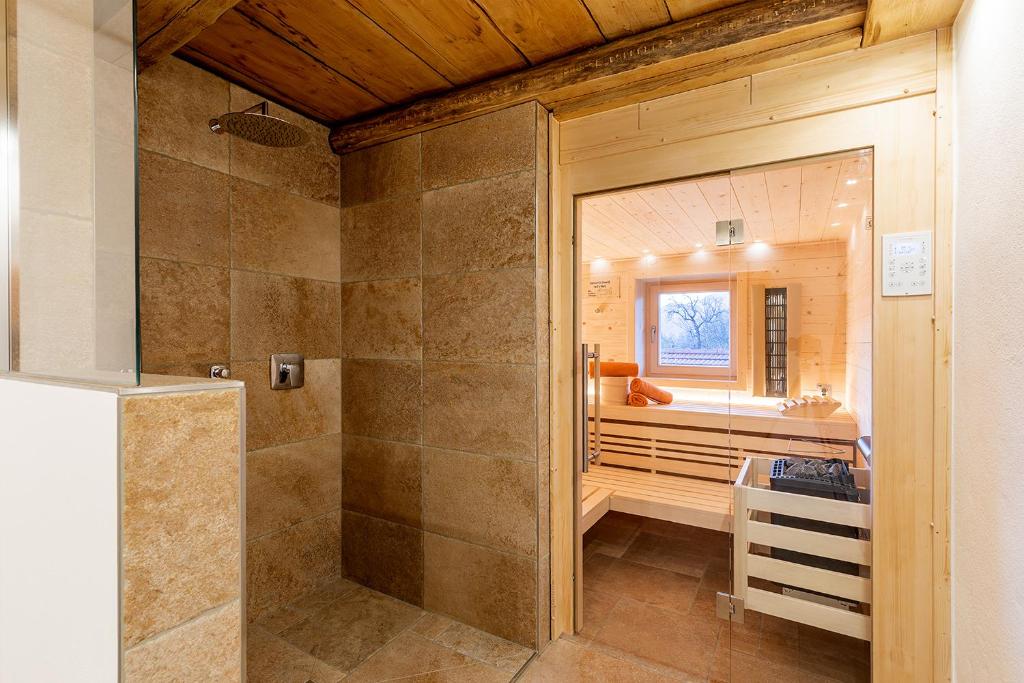 a large bathroom with a shower and a sink at Chiemgauferienwohnungen - Stierschneiderhof in Unterwössen