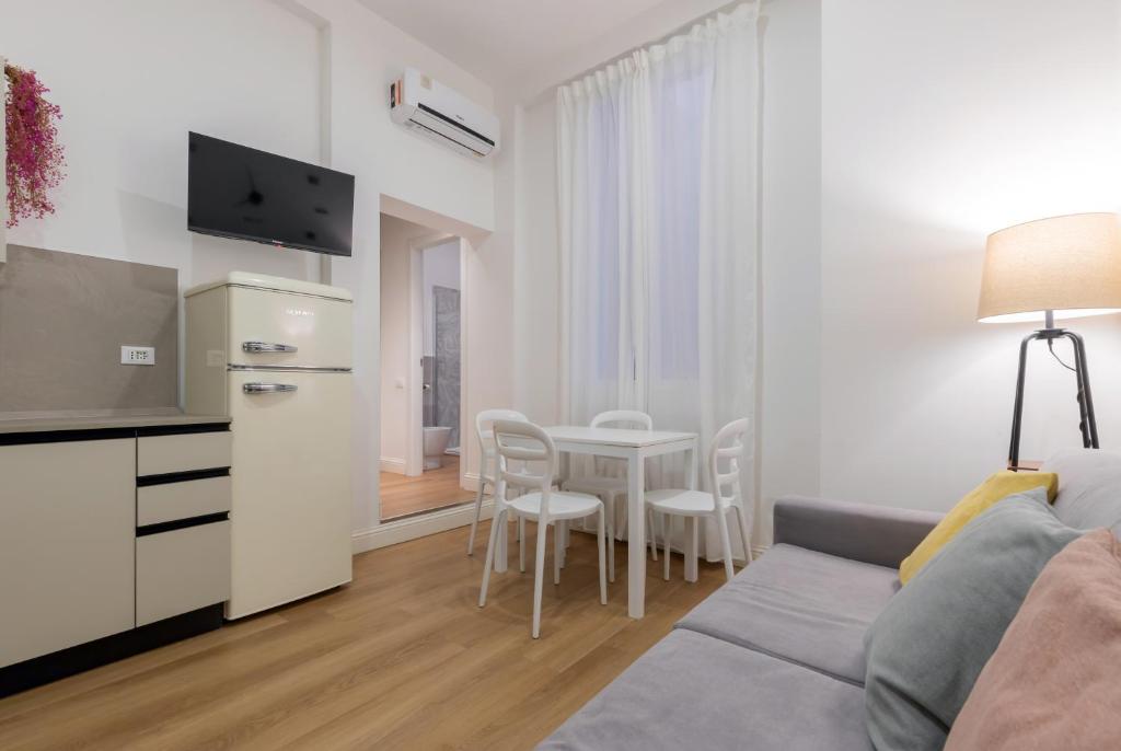 a living room with a couch and a table at Nuovo intimo APT a 10min dal Duomo - HomeUnity in Milan