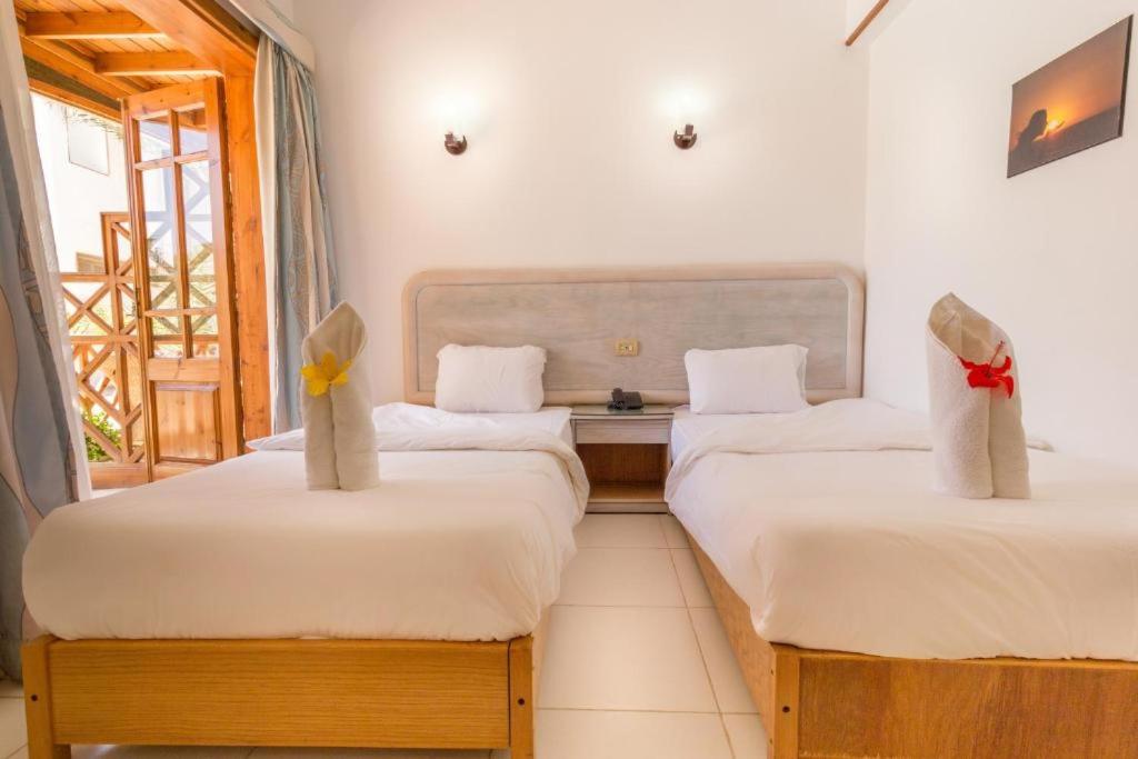 Postel nebo postele na pokoji v ubytování Acacia Dahab Hotel