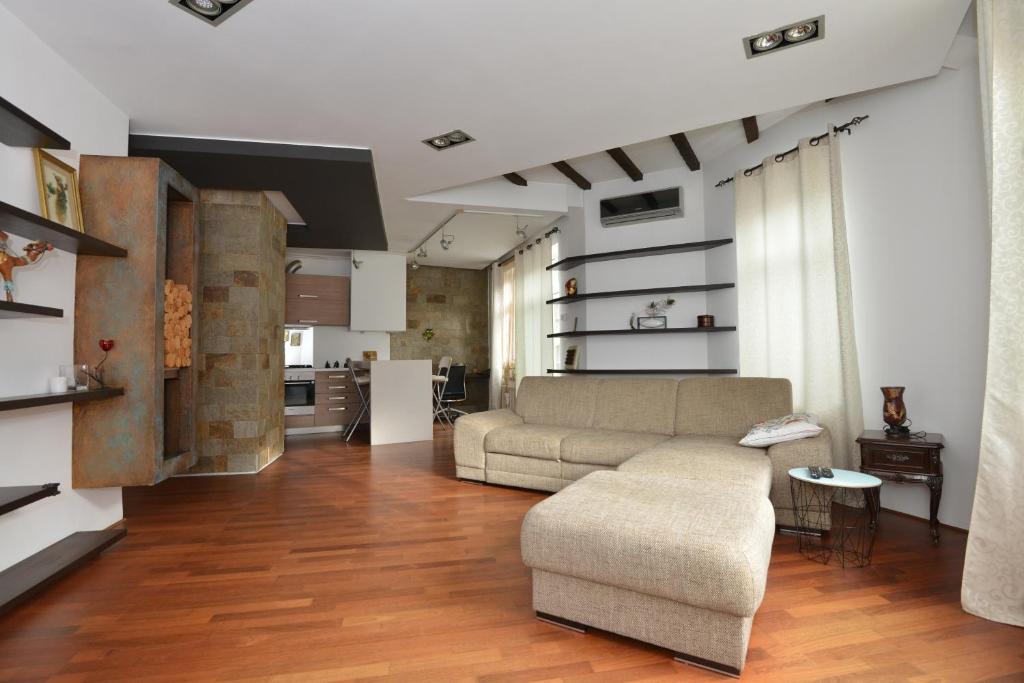 a living room with a couch and a table at Old Town Apartment Lipscani in Bucharest