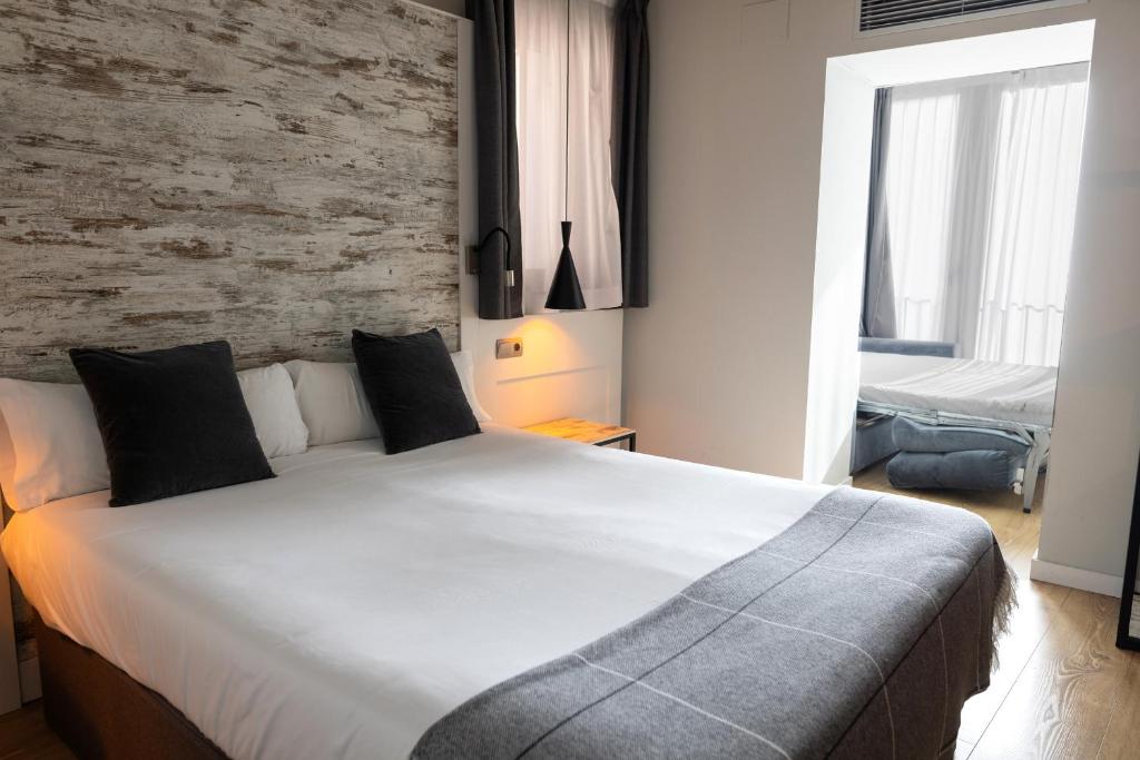 Postel nebo postele na pokoji v ubytování Hotel Cims de Camprodon