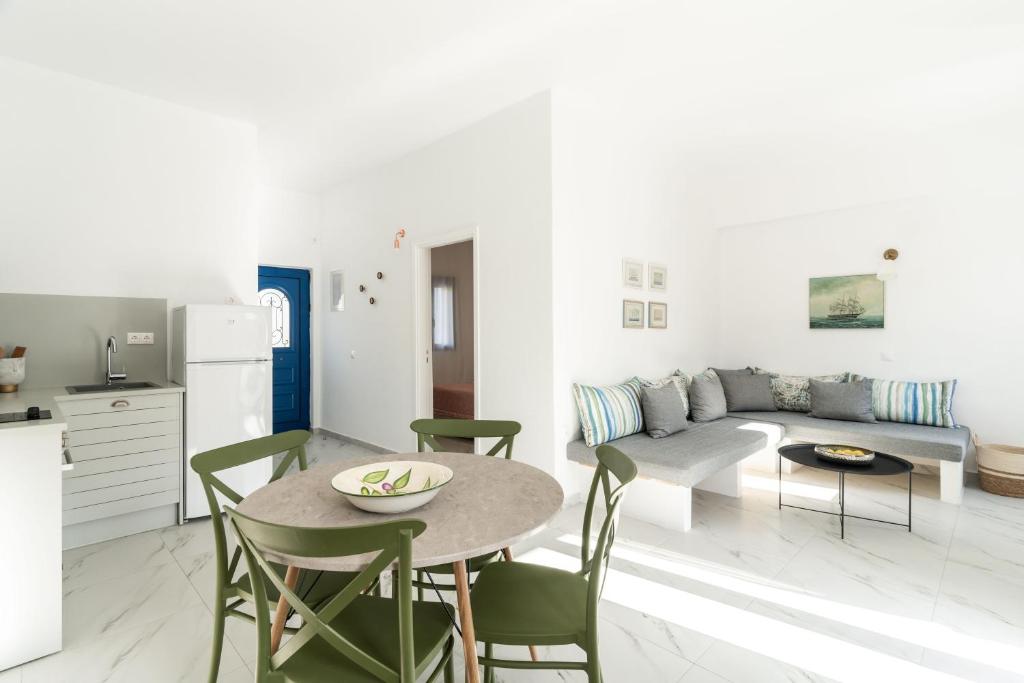 a kitchen and a living room with a table and chairs at Alasthas in Gavrio
