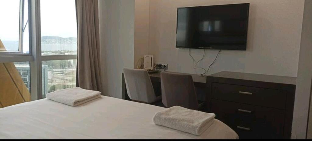 イスタンブールにあるSBK HOTELのベッド、デスク、テレビが備わるホテルルームです。