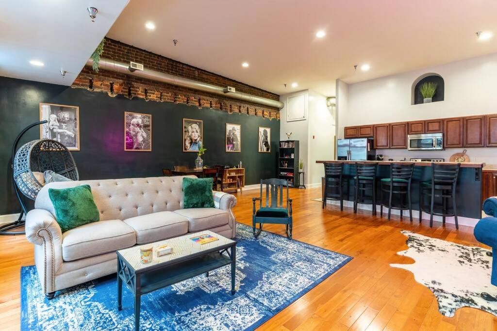 a living room with a couch and a kitchen at Jolene's Hideout in Knoxville