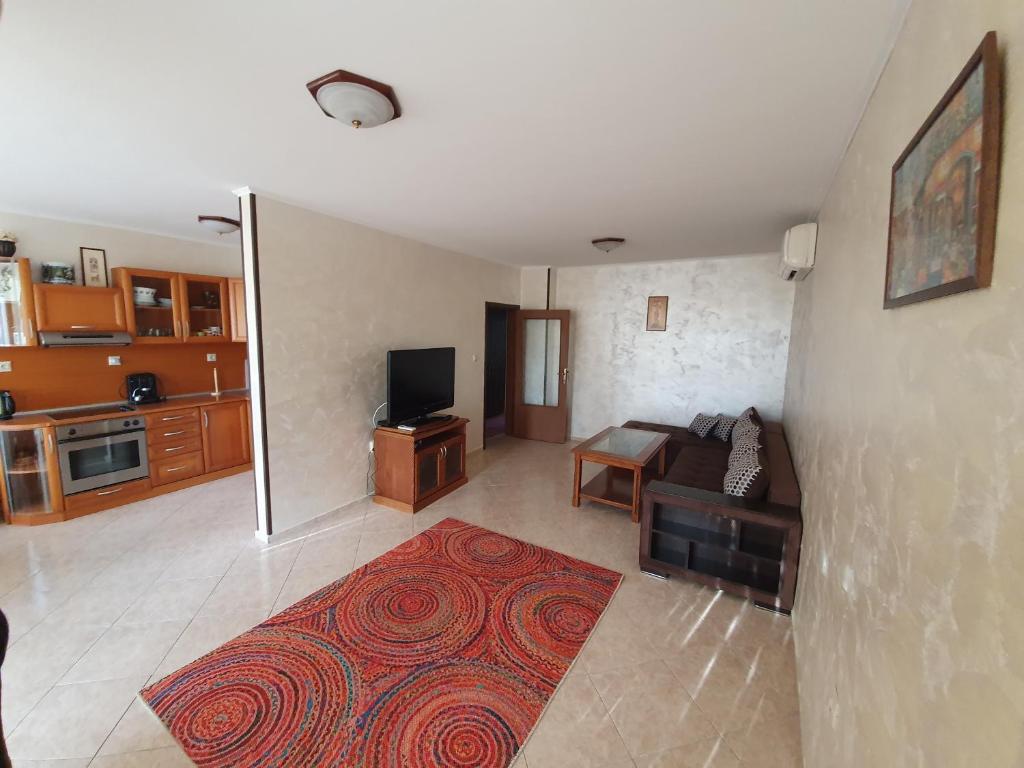 a living room with a couch and a tv at Eli 2 Sea View apartment first line in Nesebar