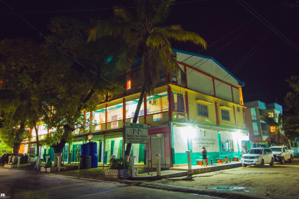 un edificio con una palmera delante de él en Hotel National Ambilobe, en Ambilobe