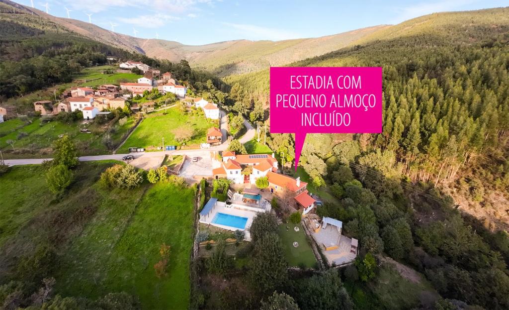 an aerial view of a house with a pink sign at BLUESKY by Camelo Casas de Campo in Camelo