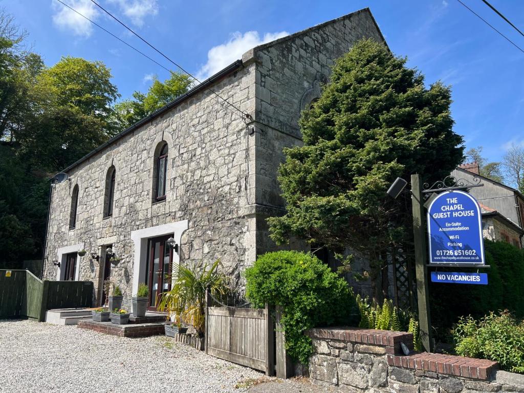 a stone building with a sign in front of it at The Chapel Guest House in St Austell