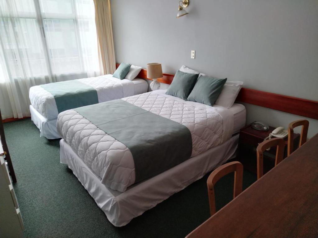 Postel nebo postele na pokoji v ubytování Apartotel Tairona