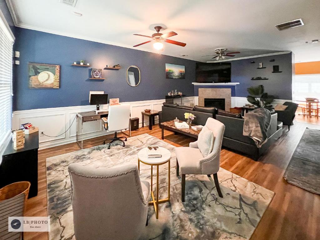 a living room with blue walls and furniture at 4 - Bed home with Cali King Bed, 12 mins to DTWN in Atlanta