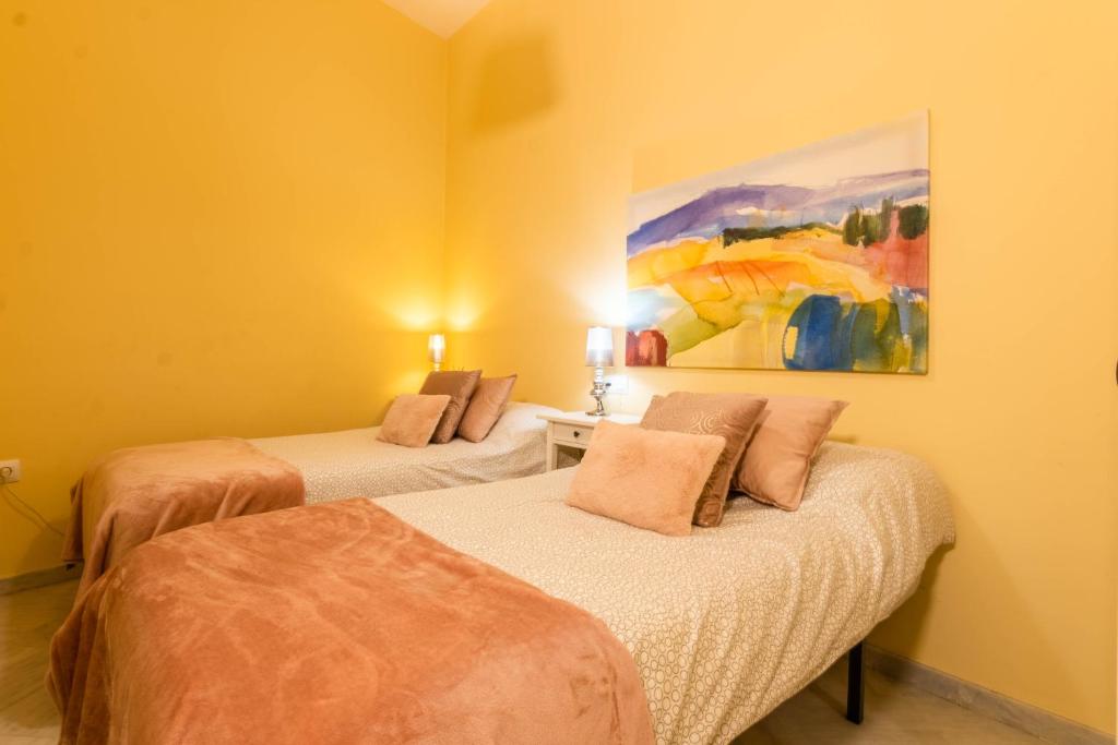 A bed or beds in a room at Apartamento DUX VERAGUA Centro Sevilla