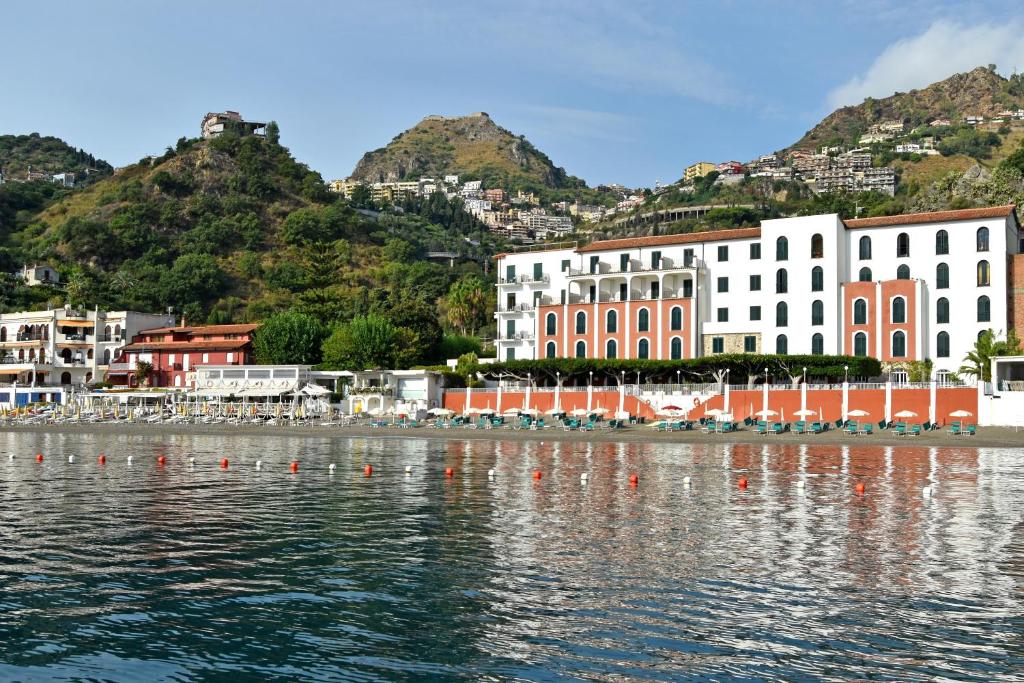 a group of buildings on the shore of a body of water at Hotel Lido Mediterranee in Taormina