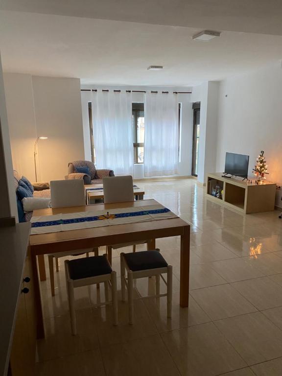 a living room with a table and chairs and a couch at Apartamentos Wei in Grao de Castellón
