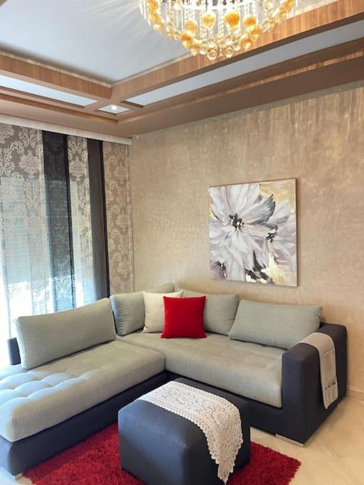 a living room with a couch and a chandelier at Big luxury apartment near airport in Nouaceur