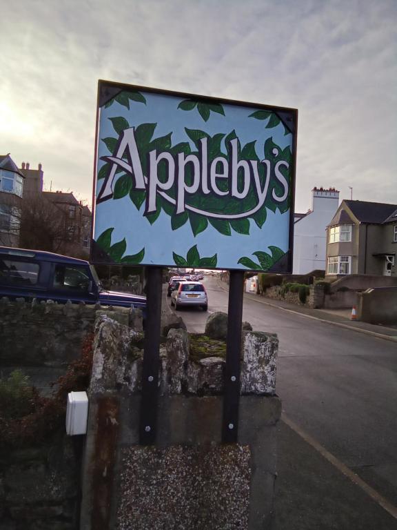 a sign on the side of a street at Applebys Guest House in Holyhead