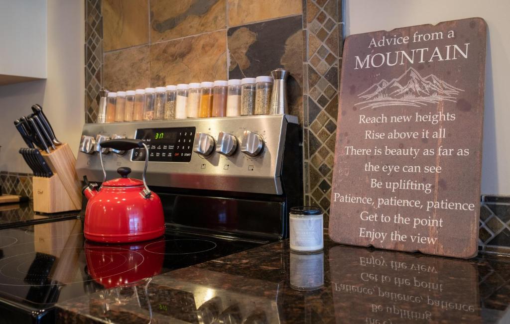 a red tea kettle sitting on top of a counter at Misty Mountain- Premium 2 Bedroom Mountain View in Canmore