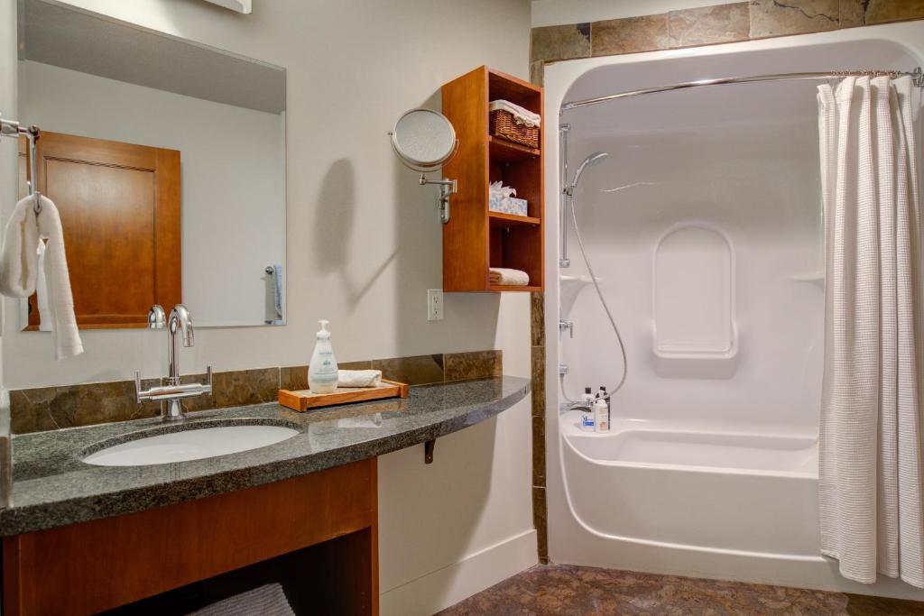 a bathroom with a sink and a shower at Misty Mountain- Premium 2 Bedroom Mountain View in Canmore