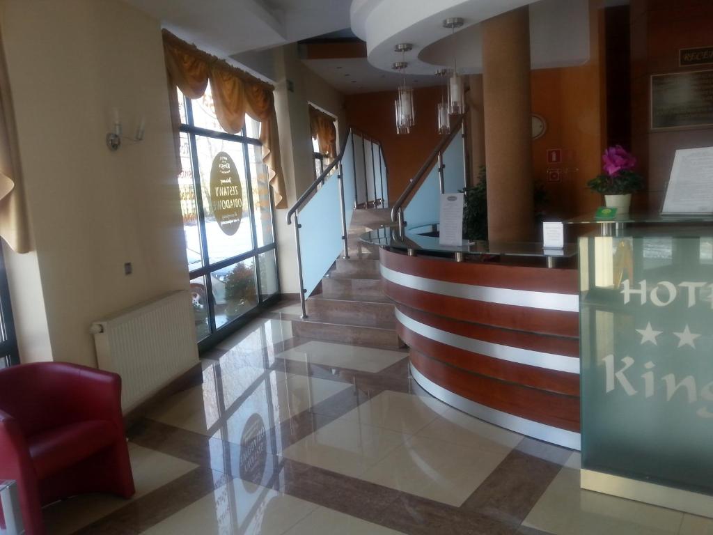 um lobby de um hotel com escadas e um bar em Hotel Restauracja Kinga em Katowice