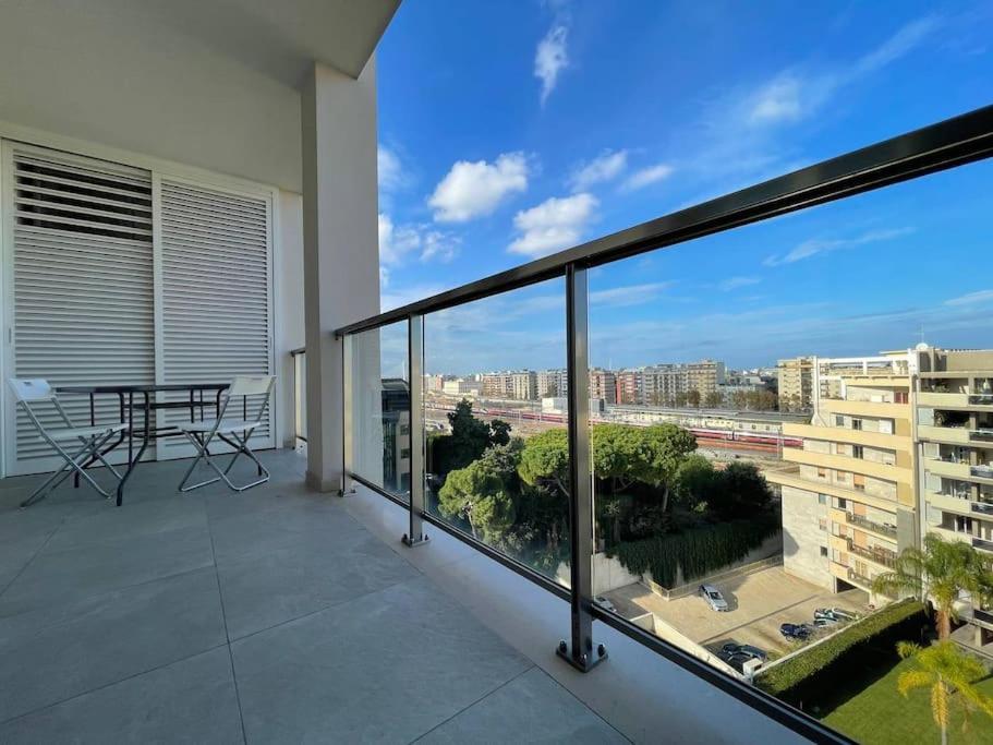 a balcony with a table and a view of a city at Boulevard Suite in Bari