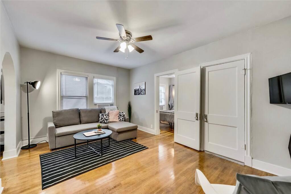 a living room with a couch and a ceiling fan at Lower-Greenville Landing Close to Everything in Dallas