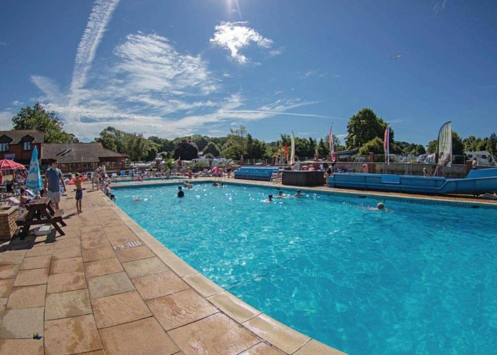 a large swimming pool with people in the water at Ladys Mile Holiday Park in Dawlish