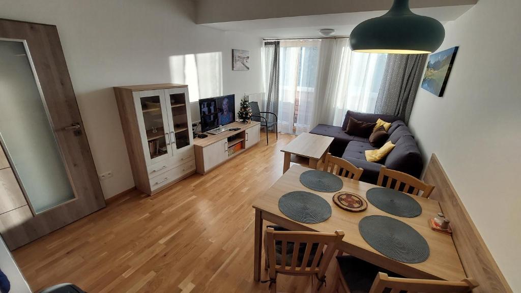 a living room with a table and a couch at Apartment Iva in Cerny Dul