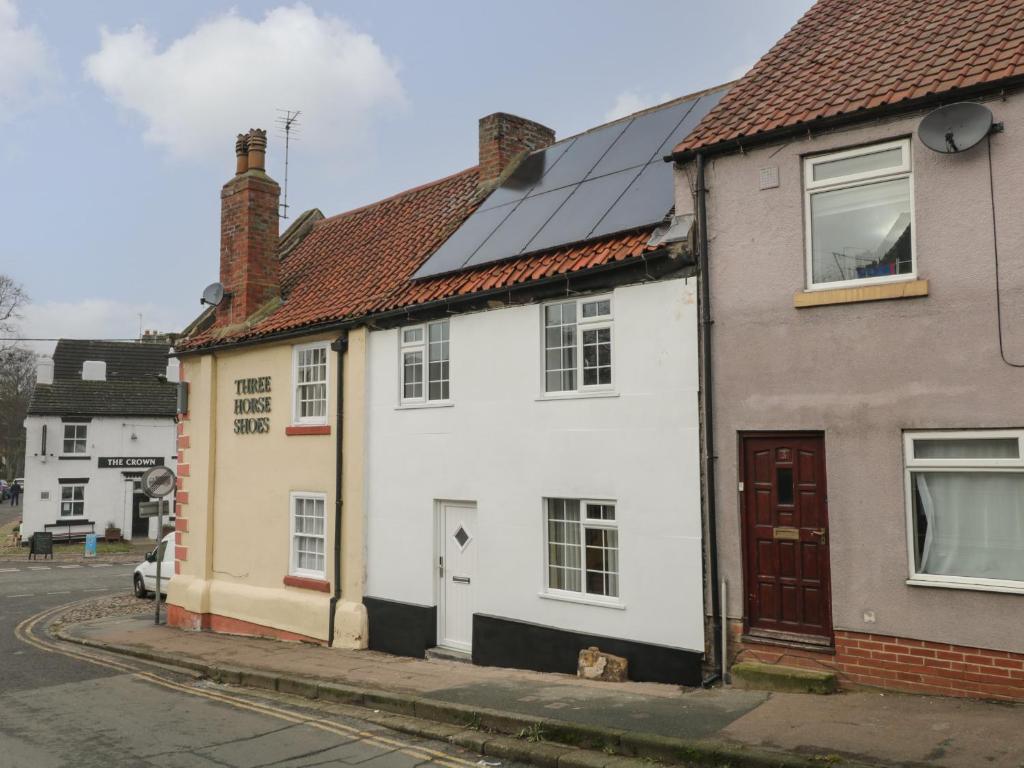 a group of houses with solar panels on their roofs at Blacksmiths Cottage in Northallerton