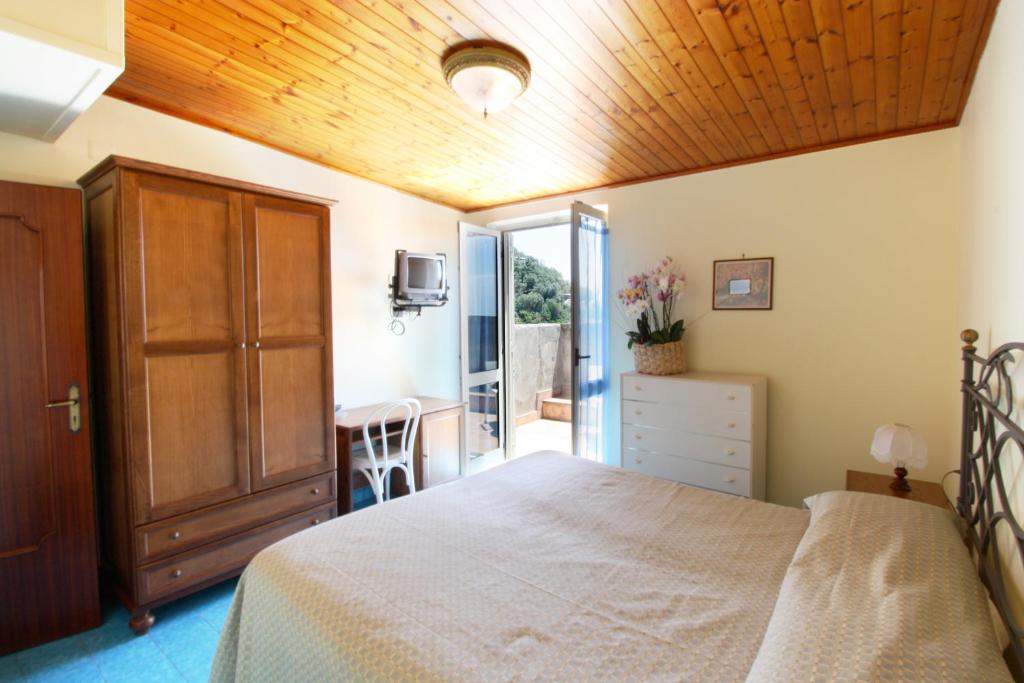 a bedroom with a bed with a wooden ceiling at Hotel La Certosa in Massa Lubrense