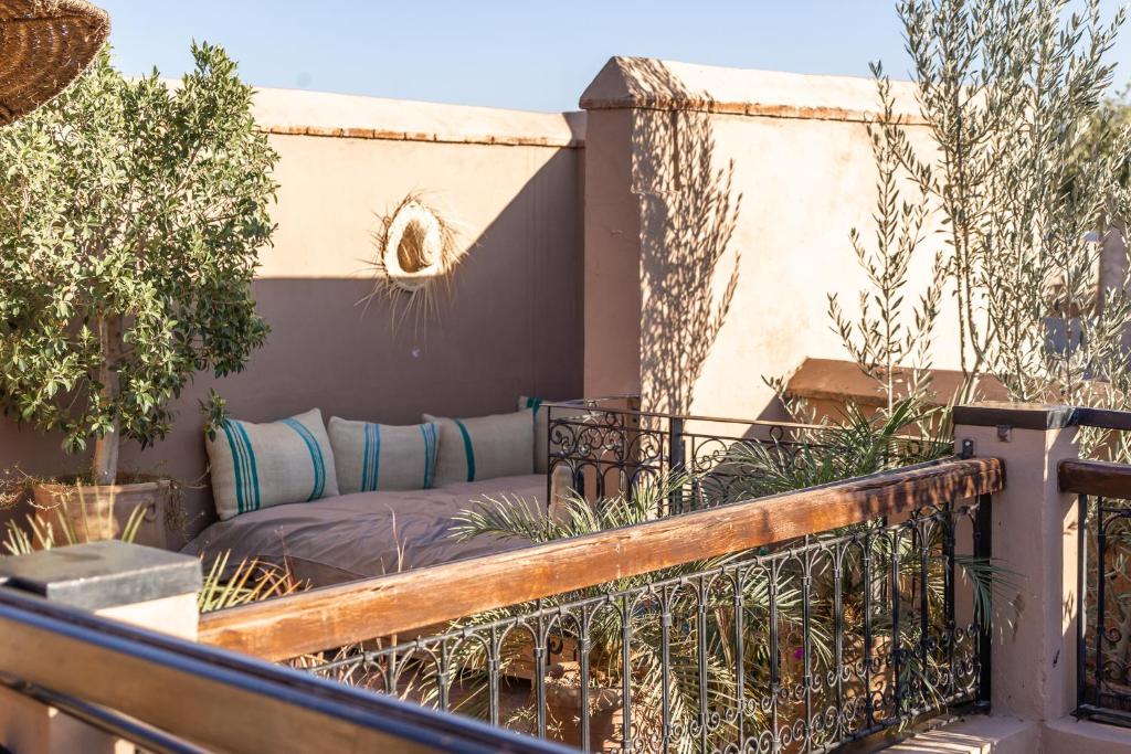 a porch with a couch on a balcony at Riad Dar Beldia and Spa in Marrakesh