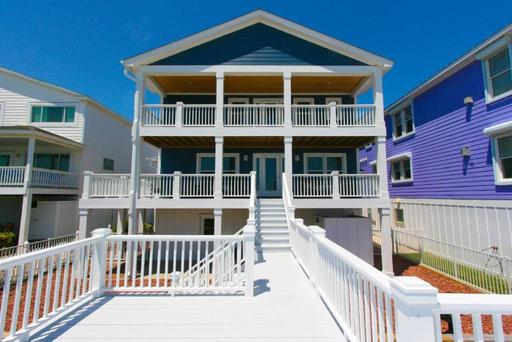 a row of houses with a purple house at Oceanfront - Decks For Days in Kure Beach