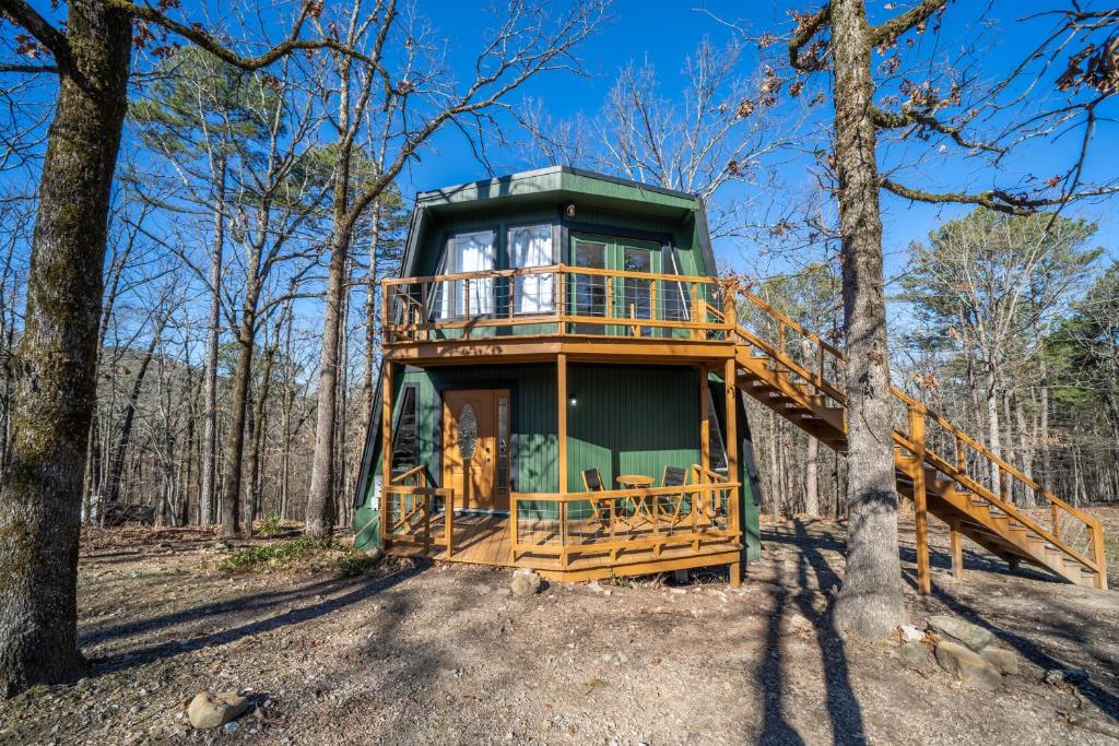 a tree house with a deck in the woods at The Haven in Hot Springs