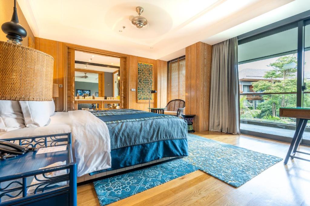 a bedroom with a bed and a large window at Hotel Indigo Bali Seminyak Beach by IHG in Seminyak
