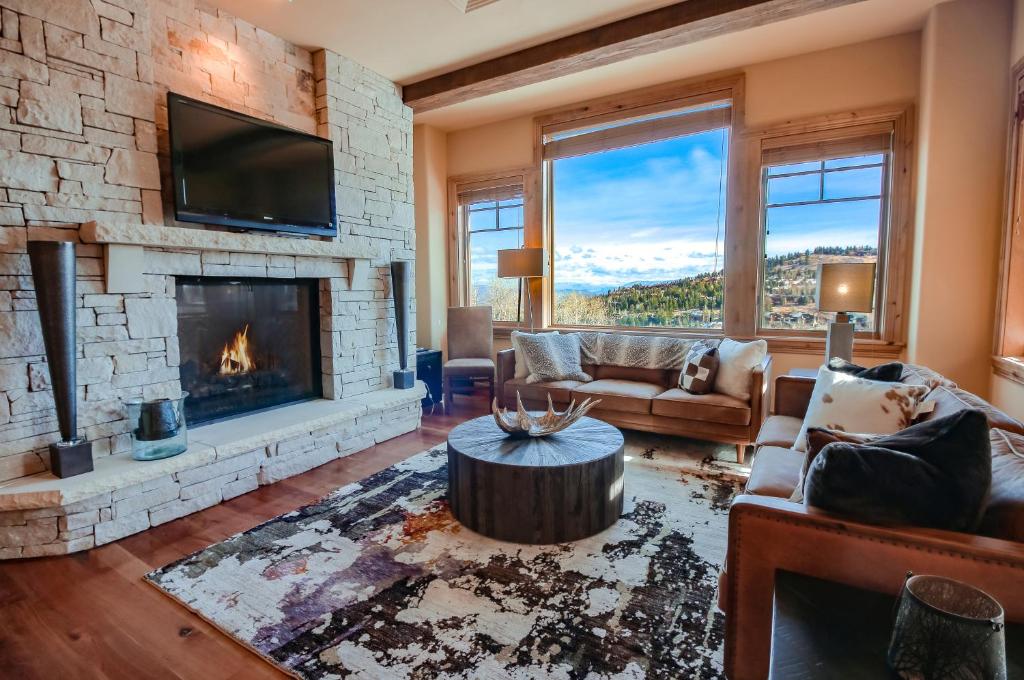 a living room with a fireplace and a tv at Silver Strike Condo by Lespri Property Management in Park City
