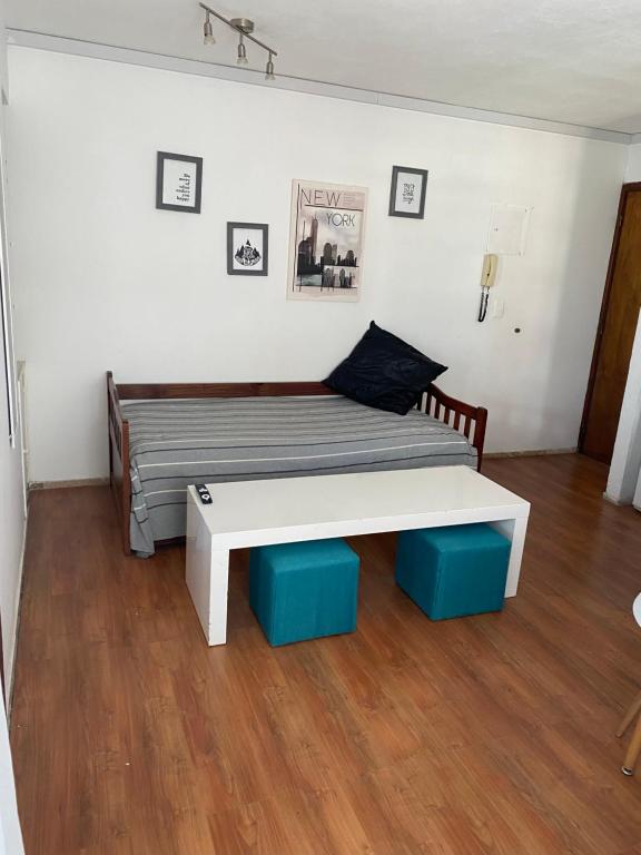 1 cama con banco en una habitación en Apartamento a pasos del mar de Playa Brava, en Punta del Este