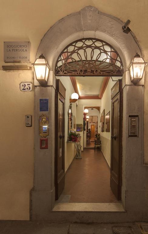 Hotel Soggiorno La Pergola, an entrance to a building with an archway and lights at Soggiorno La Pergola in Florence