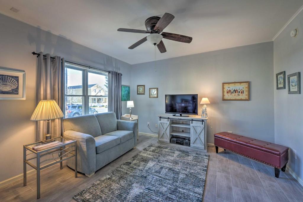 a living room with a couch and a flat screen tv at Serene West Cape May Getaway Walk to Beach! in Cape May