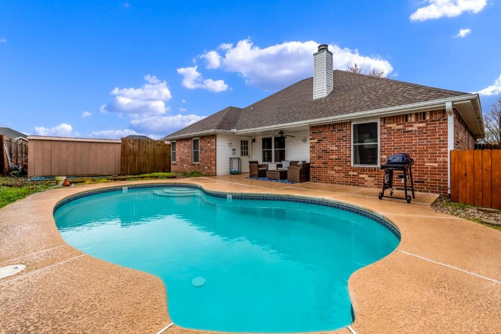 a swimming pool in front of a house at The Betty in Bentonville
