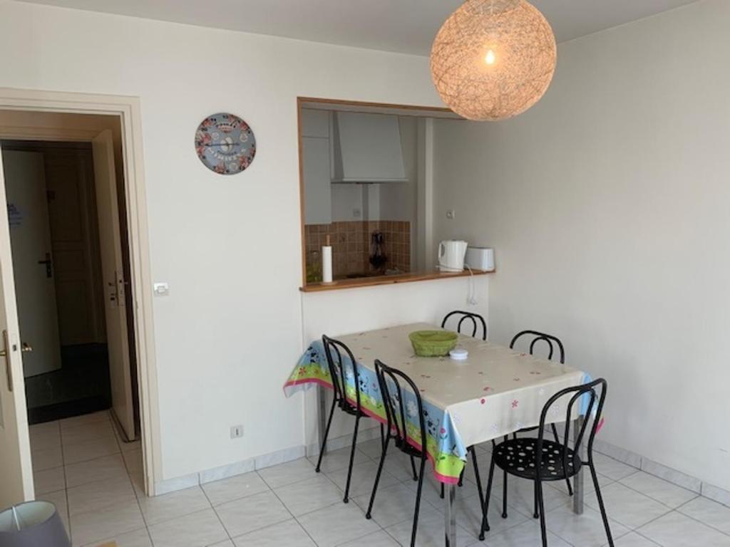 a kitchen with a table and chairs in a room at Appartement Mont-Dore, 2 pièces, 4 personnes - FR-1-415-129 in Le Mont-Dore