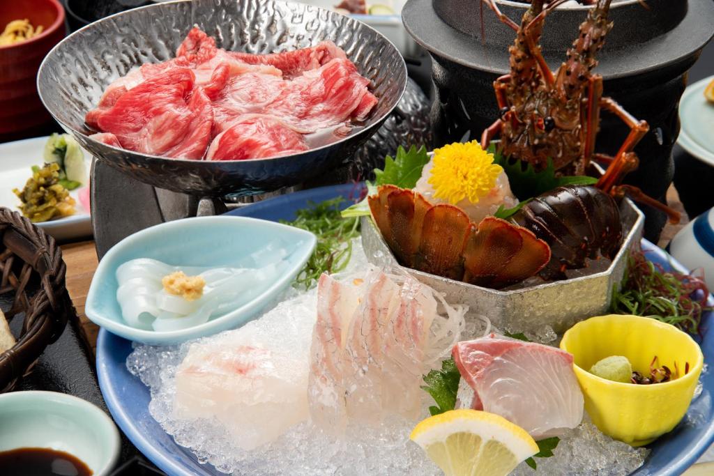 a plate of food with seafood on a table at Fukujyuso in Shima