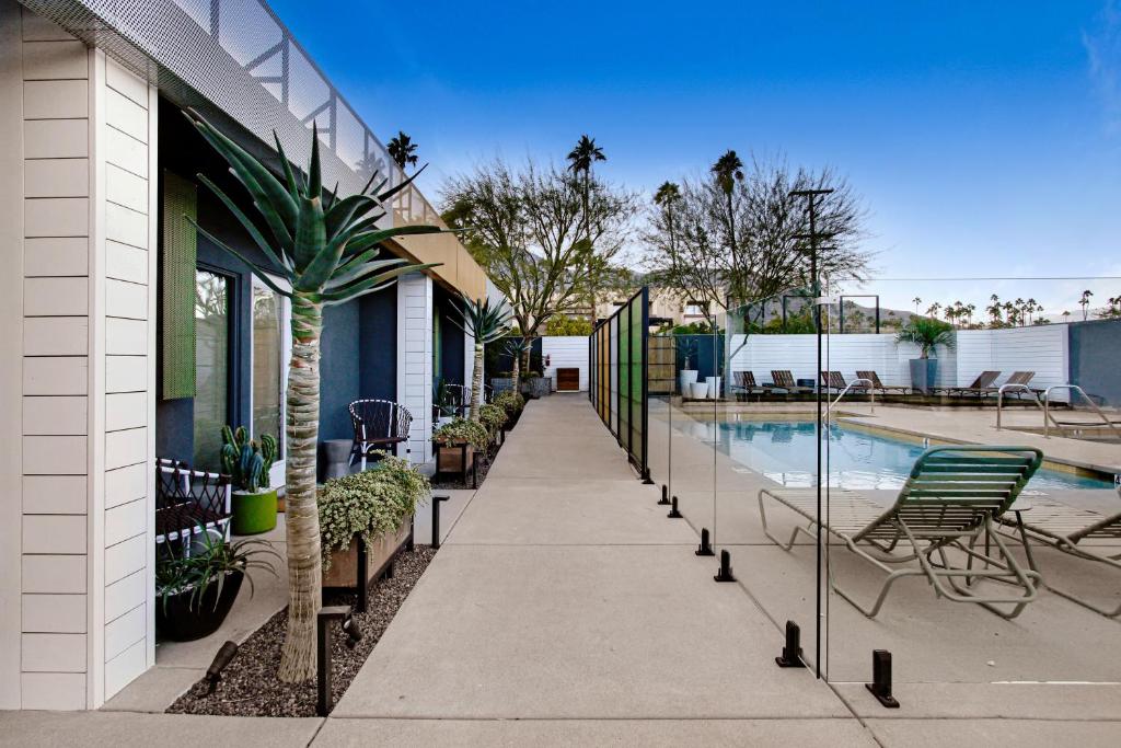 a walkway next to a house with a swimming pool at Mahala in Palm Springs