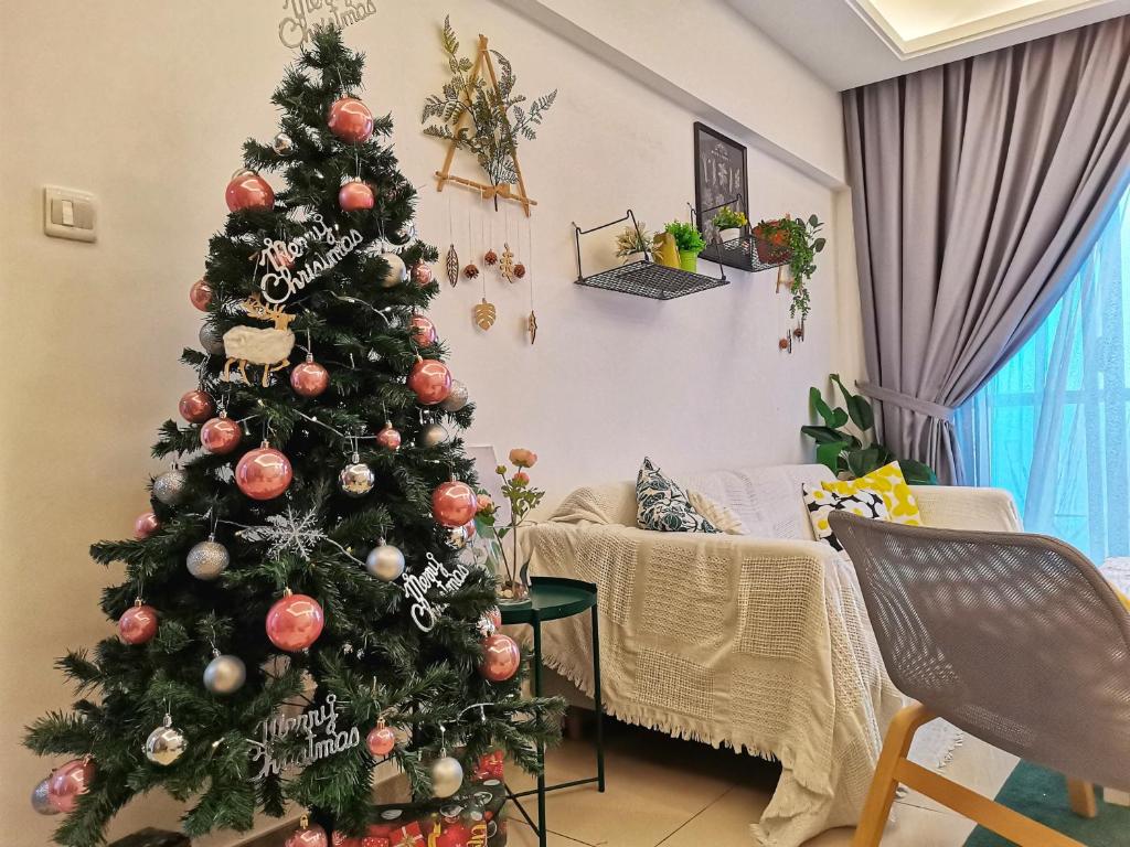 a christmas tree in a living room at R&F Mall,Country Style Seaview 2 bedrooms in Johor Bahru