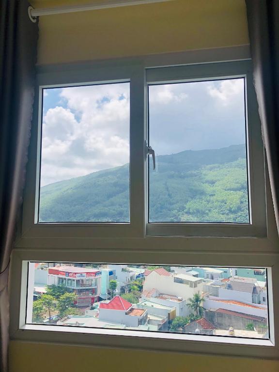 a window with a view of a city at Căn hộ hướng núi mới ở thành phố Quy Nhơn in Quy Nhon